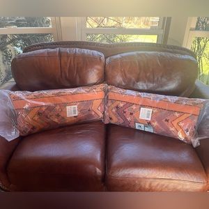 A pair of Bohemian pillows made by Karma Living in peach with embroidery